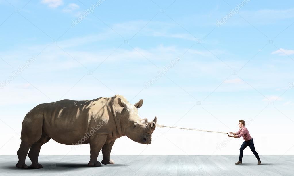 Man holding rhino