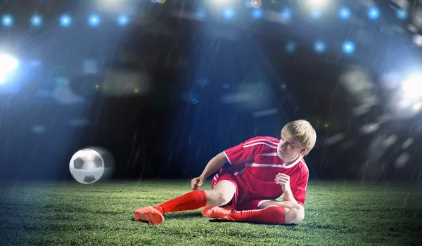 Football player doing slide tackle — Stock Photo, Image