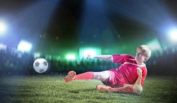 Football player doing slide tackle — Stock Photo, Image