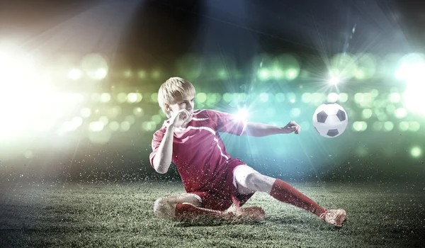 Football player doing slide tackle — Stock Photo, Image
