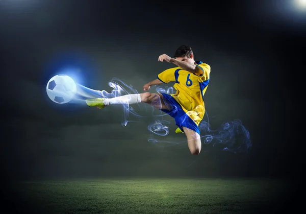 Voetbal speler rekening houdend bal — Stockfoto