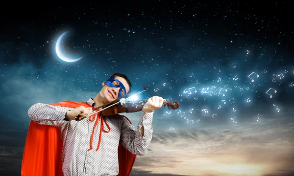 Superman playing violin — Stock Photo, Image