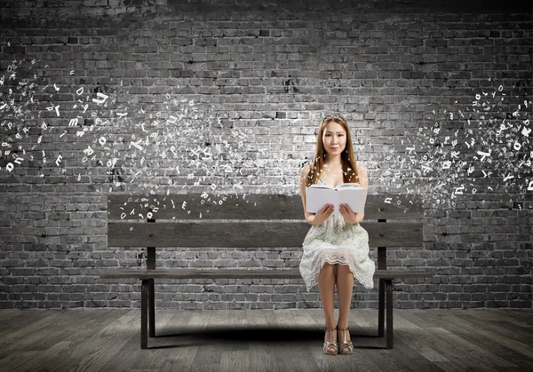 Girl reading book Stock Image