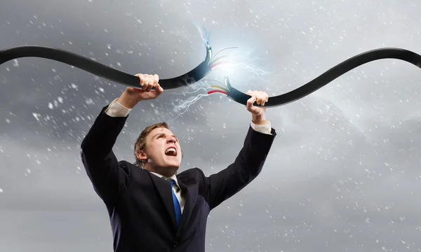 Man tearing cable — Stock Photo, Image