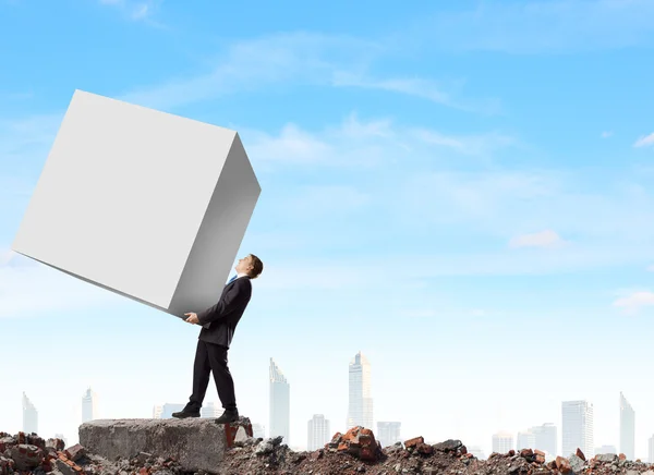 Businessman carrying cube — Stock Photo, Image