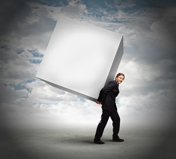 Businessman carrying cube — Stock Photo, Image