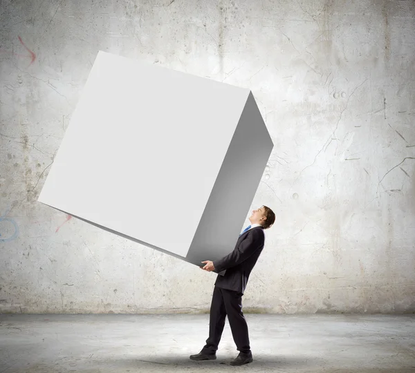 Businessman carrying cube — Stock Photo, Image