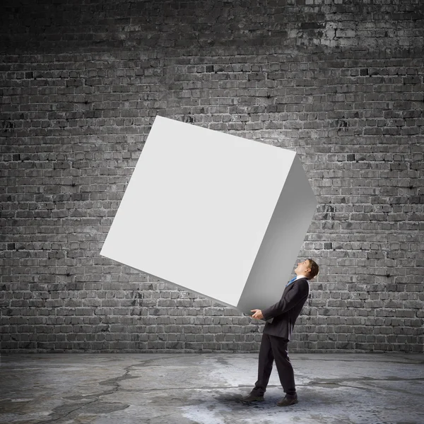 Businessman carrying cube — Stock Photo, Image