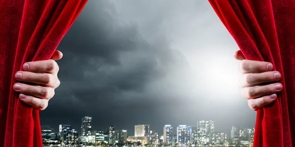 Close up of hand opening red curtain — Stock Photo, Image