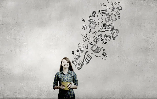 Young girl holding bucket with flying out sketche — Stock Photo, Image