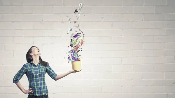 Young woman in casual holding yellow bucket — Stock Photo, Image