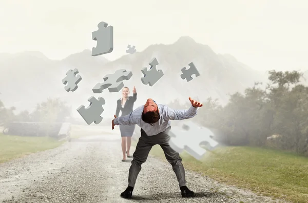 Man evading flying puzzle — Stock Photo, Image