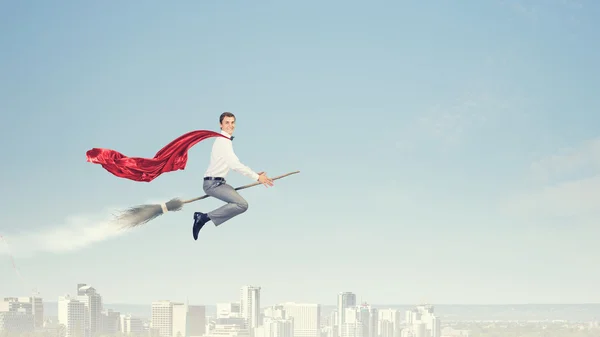 Businessman on broom — Stock Photo, Image