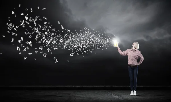 Woamn splashing charcters from bucket — Stock Photo, Image