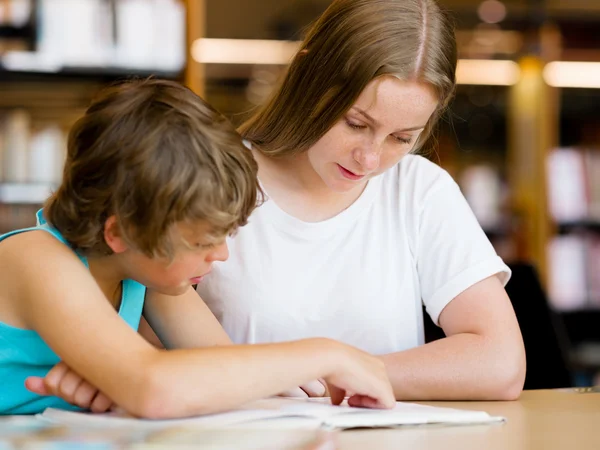 Adolescente et son frère avec des livres — Photo