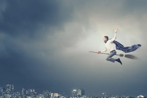 Businessman on broom — Stock Photo, Image