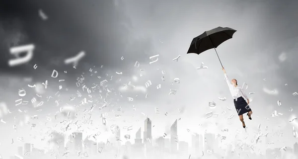 Woman fly on umbrella — Stock Photo, Image