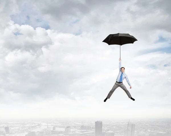 Man fly on umbrella — Stock Photo, Image