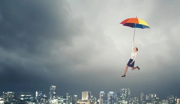 Woman fly on umbrella — Stock Photo, Image