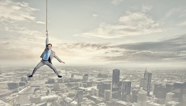 Man hang on rope — Stock Photo, Image