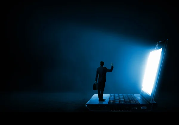 Man standing on big laptop — Stock Photo, Image