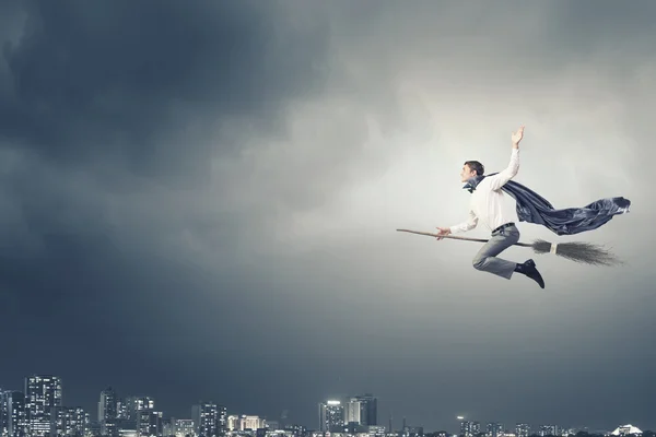 Businessman on broom — Stock Photo, Image