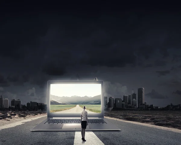 Woman standing on big laptop — Stock Photo, Image