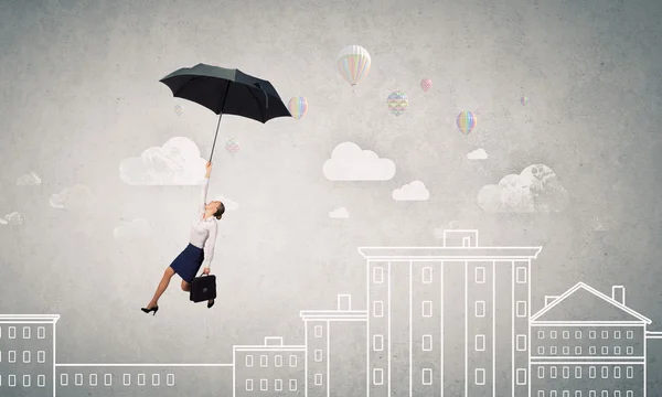 Woman fly on umbrella — Stock Photo, Image