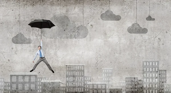 Man fly on umbrella — Stock Photo, Image