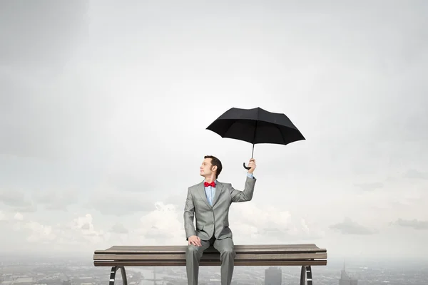 Businessman with umbrella Royalty Free Stock Images
