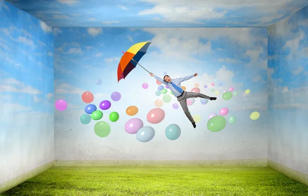 Man fly on umbrella — Stock Photo, Image