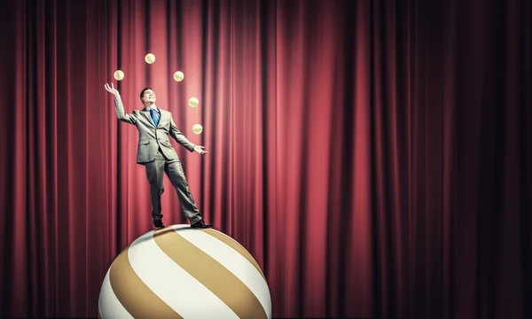 Businessman juggling with balls — Stock Photo, Image