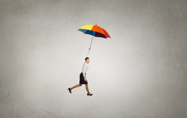 Woman fly on umbrella — Stock Photo, Image