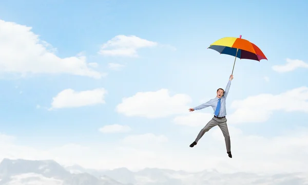 Man fly on umbrella — Stock Photo, Image