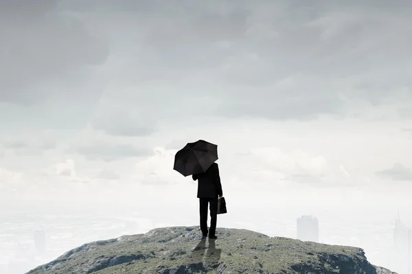 Businessman with umbrella — Stock Photo, Image