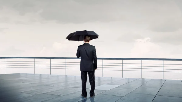 Businessman with umbrella — Stock Photo, Image