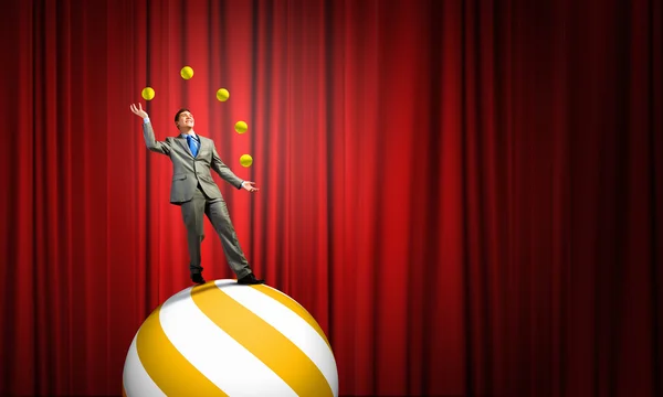 Businessman juggling with balls — Stock Photo, Image