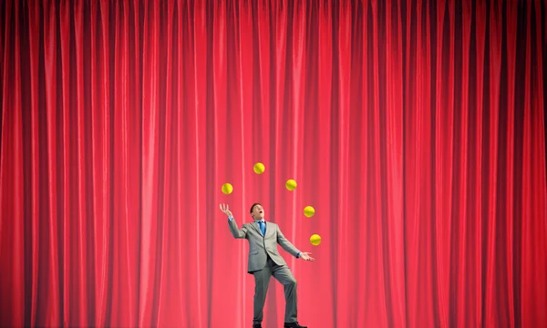 Businessman juggling with balls — Stock Photo, Image