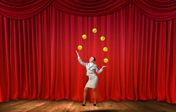 Businesswoman juggling with balls — Stock Photo, Image