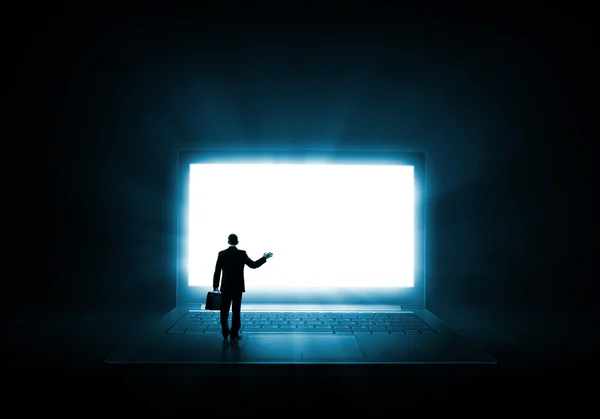 Man standing on big laptop — Stock Photo, Image