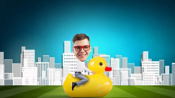 Businessman on rubber duck — Stock Photo, Image