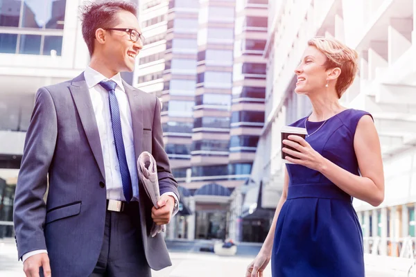 Twee collega's lopen samen in een stad — Stockfoto