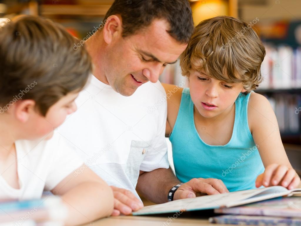 Father with sons in library
