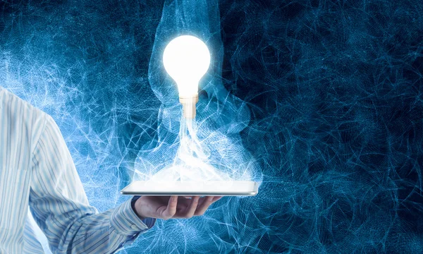 Bulb on tablet — Stock Photo, Image