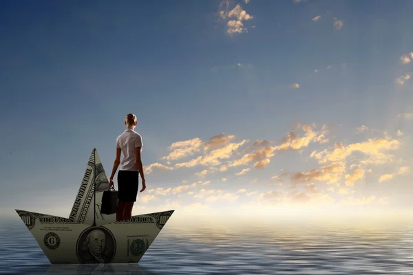 Woman in dollar boat — Stock Photo, Image
