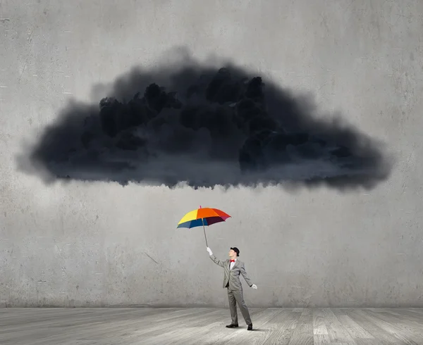 Businessman with colorful umbrella — Stock Photo, Image