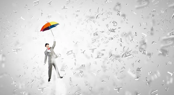 Man fly on umbrella — Stock Photo, Image