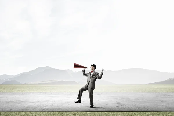 Businessman in hat with trumpet — Stock Photo, Image