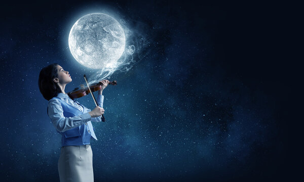 Young woman playing violin and full moon in sky