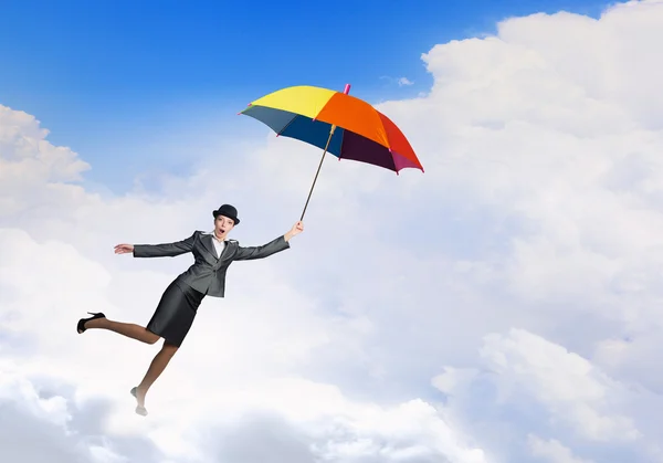 Woman flying on umbrella — Stock Photo, Image
